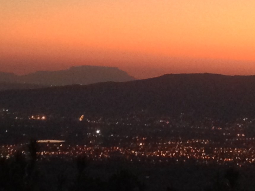 The lights of Paarl below as Table Mountain dominates the evening sky